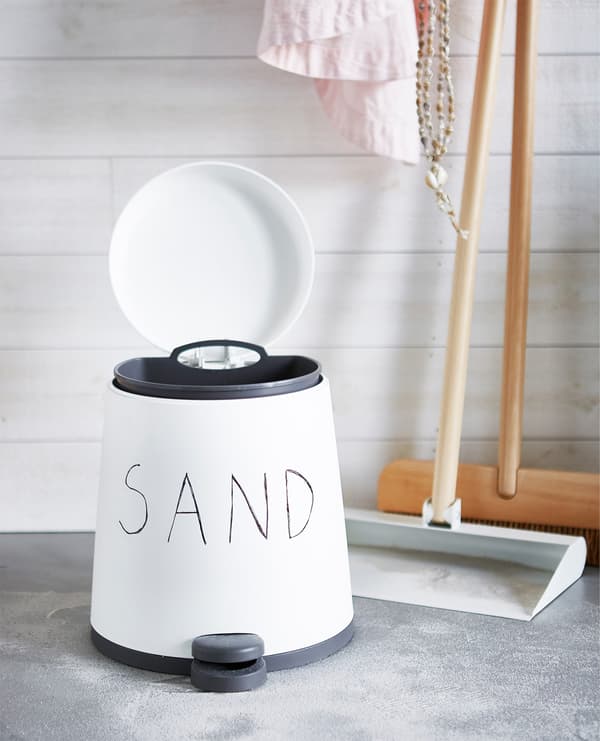 A bin for sand and a dustpan with broom.