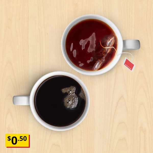 A birch effect background with a cup of black coffee and tea. A breath-taking price tag in yellow-red with black text that reads 