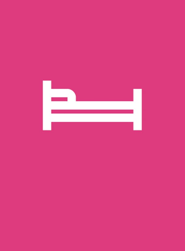 A black and white graphic symbol of a bed