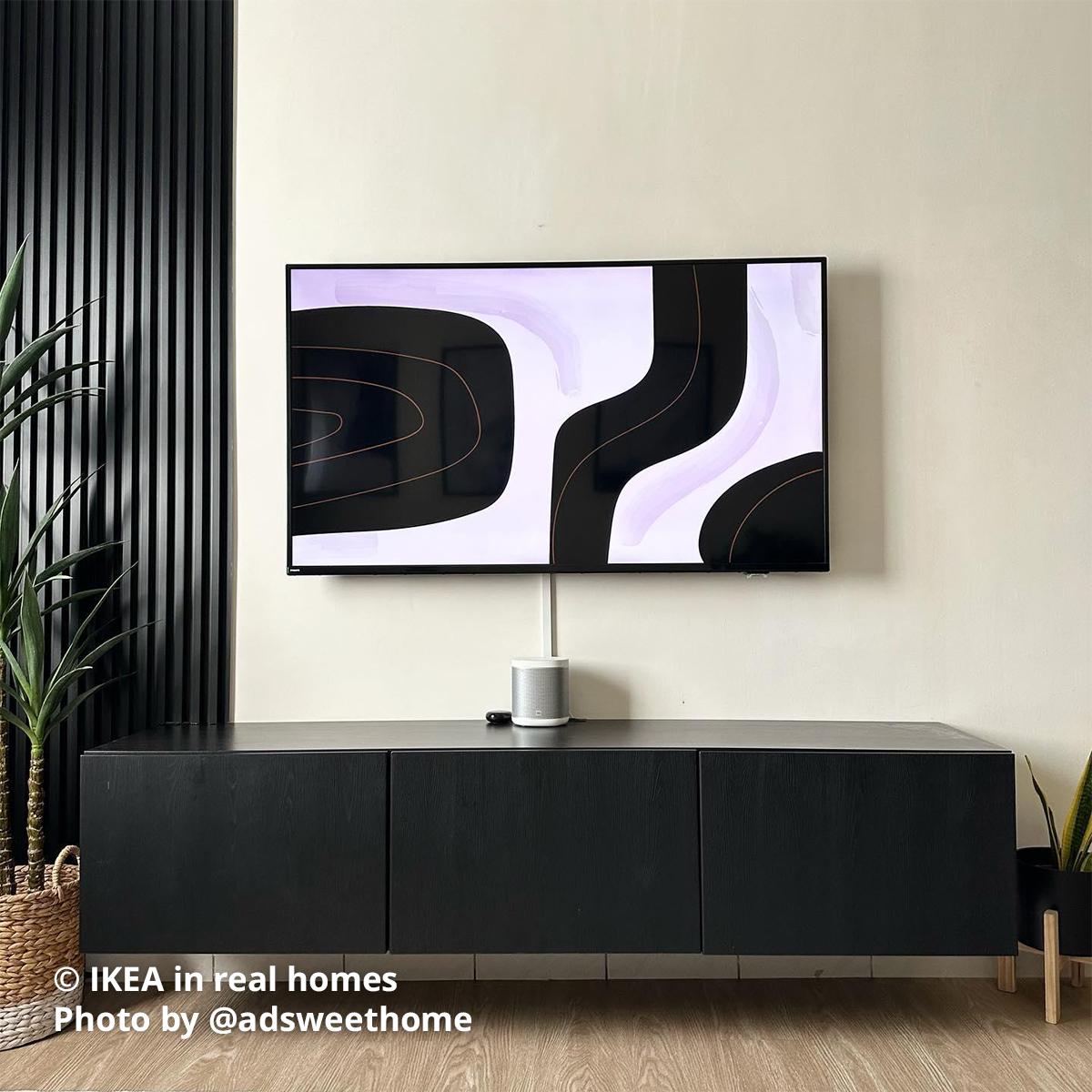 A black-brown BESTA TV bench mounted onto the wall in a living room setting . IKEA in real homes Photo by @adsweethome