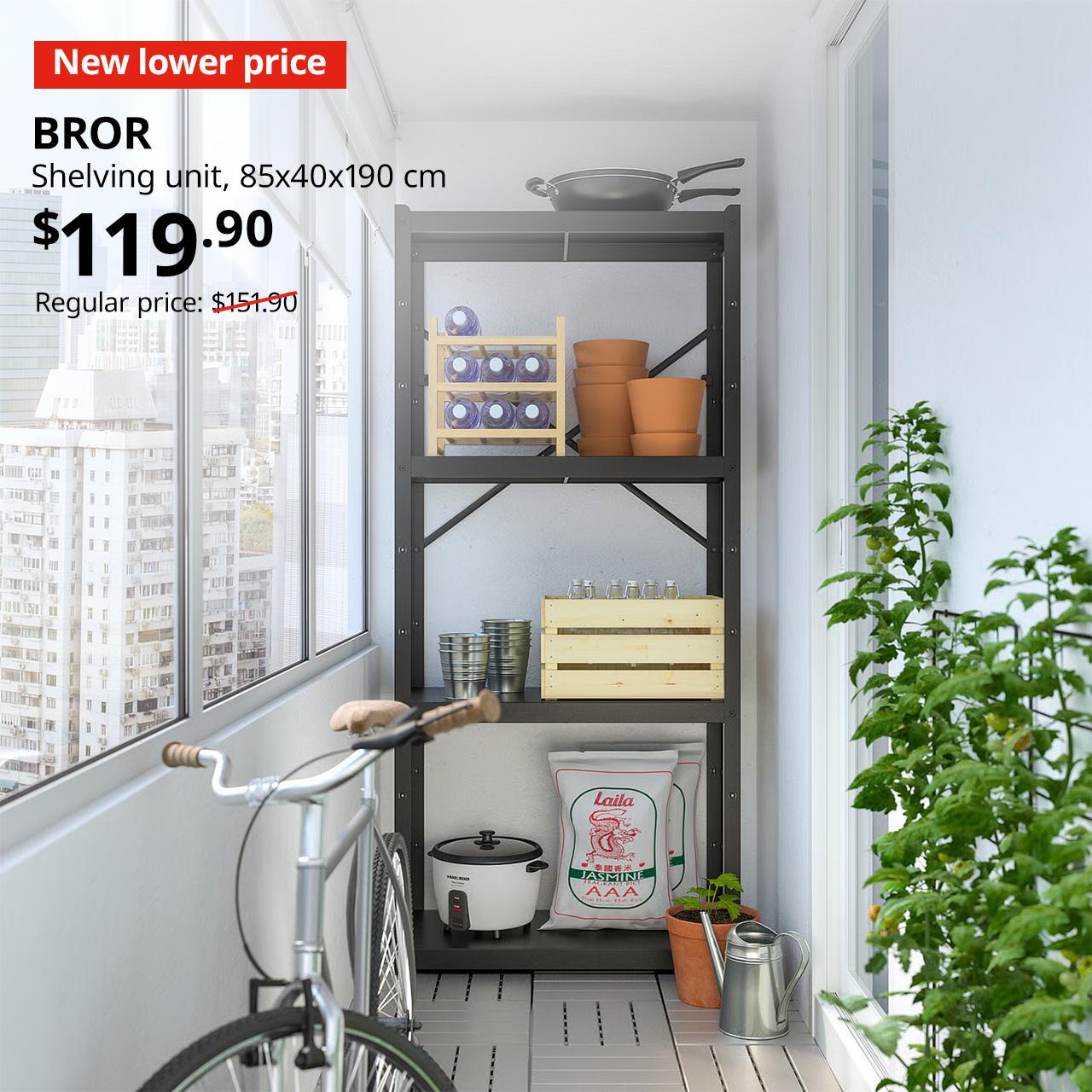 A black frame BROR shelving unit is being used at the service yard for extra storage. A 'New lower Price' red tag with white text. Text in white that reads, BROR, Shelving unit, 85x40x190 cm. Price: $119.90. Usual price with red slash: $151.90".