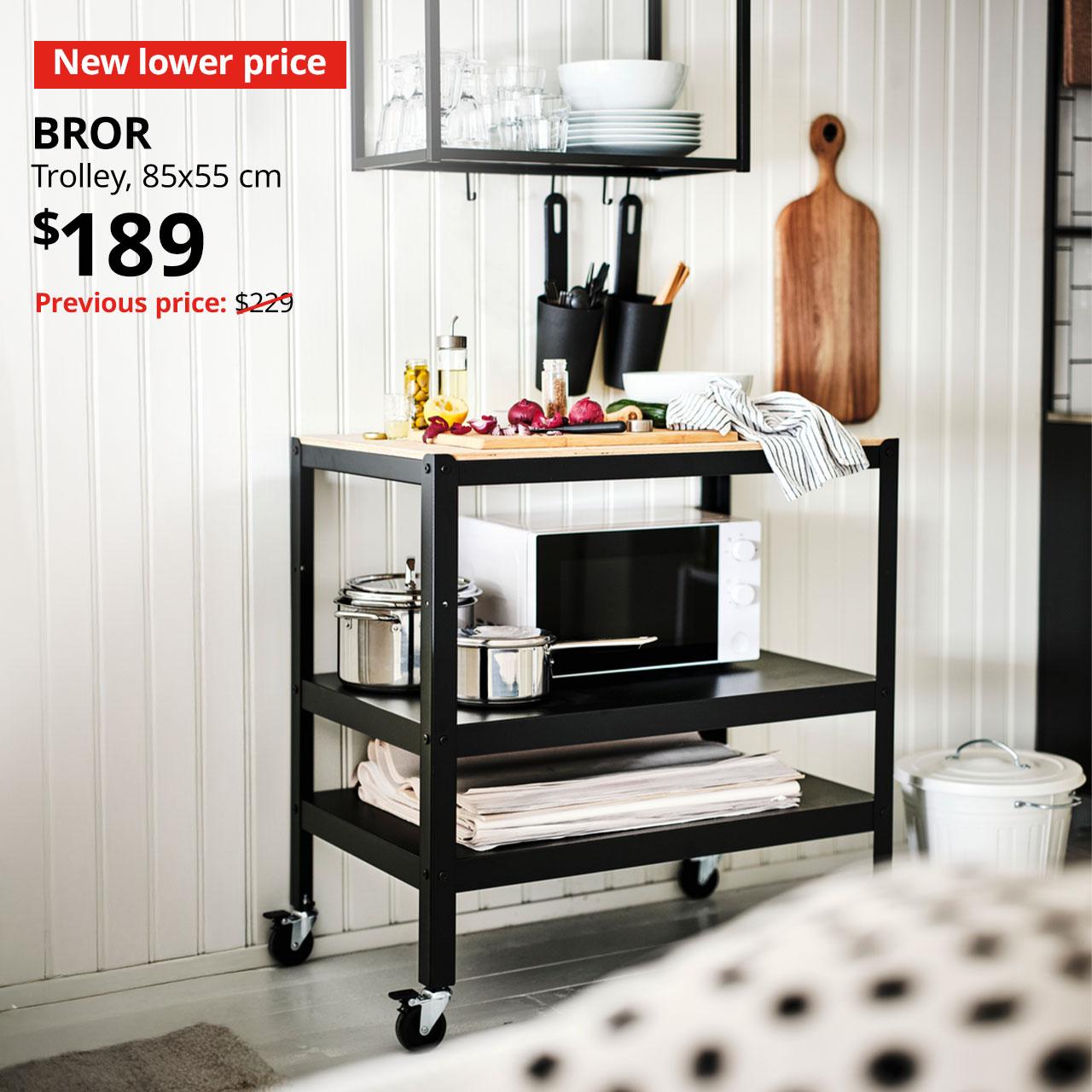 A black frame with pine plywood BROR trolley in the kitchen setting. A 'New lower Price' red tag with white text. Text in white that reads, BROR, Trolley, 85x55 cm. Price: $189. Usual price with red slash: $229".