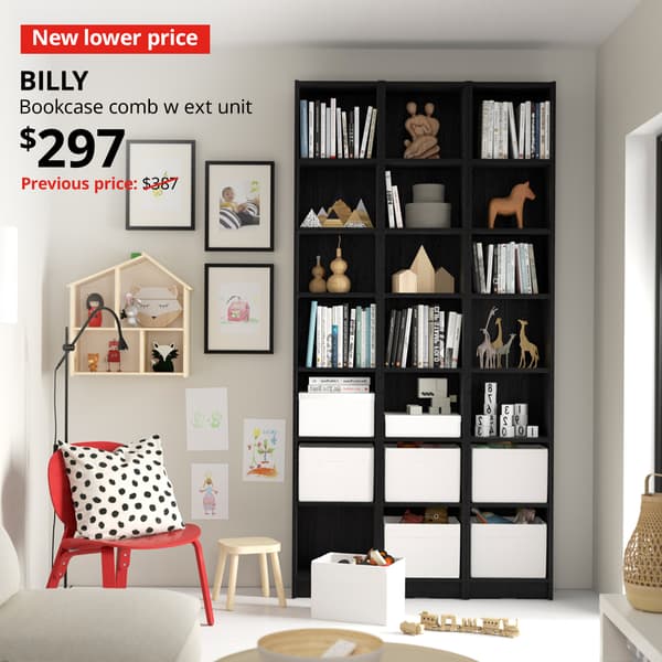 A black oak effect BILLY bookcase combination with extension unit in a living room setting. A red tag with white text that reads "New lower price" alongside with black text that reads "BILLY, Bookcase comb w ext unit, $297. Previous price: $387 slashed"