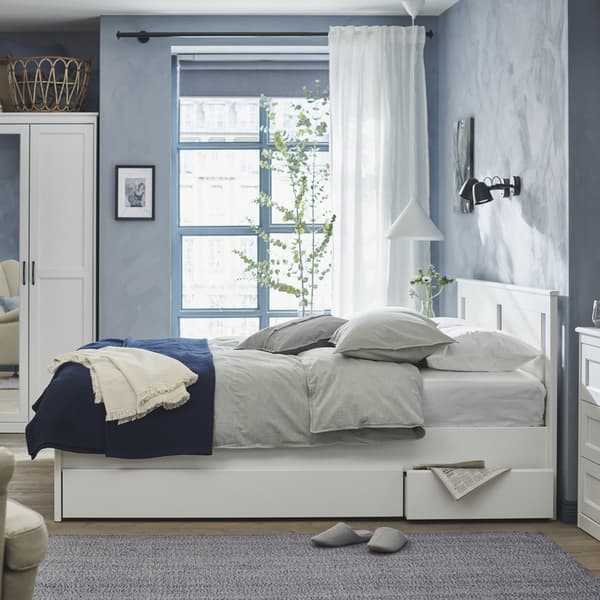 Image 25: A black SKURUP wall lamp in the bedroom