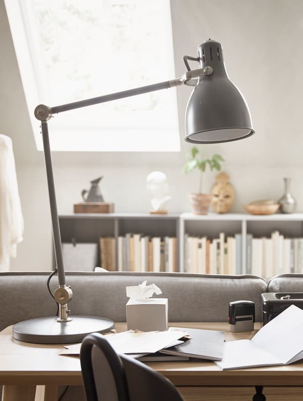 A black table lamp on top of a desk.