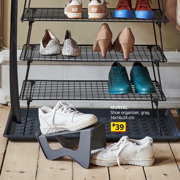 A black three-tier wire shoe organizer holds heels and sneakers, with white shoes below. A product label shows “MURVEL,” gray, 14×14×24 cm, ₱39.