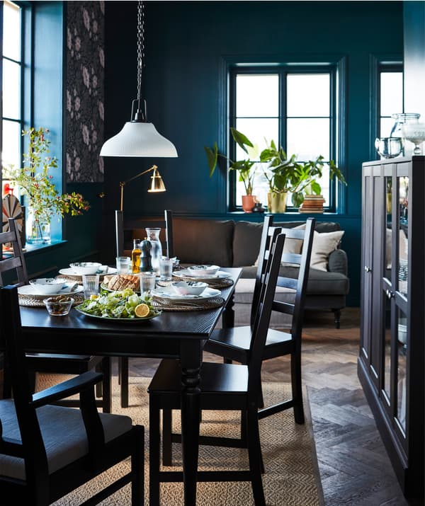 A black, traditional style IKEA INGATORP extendable table in a dining setting.