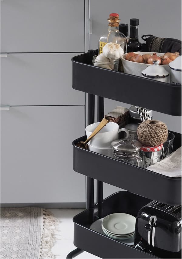 A black trolley with three storage shelves. 
