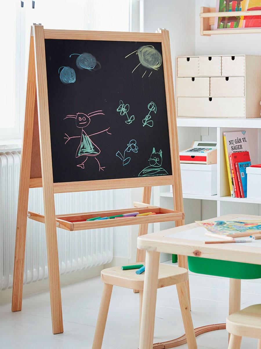 a blackboard filled with a drawing in a classroom with a small table and storage accessories in the background