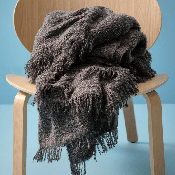 A blanket on a wooden chair