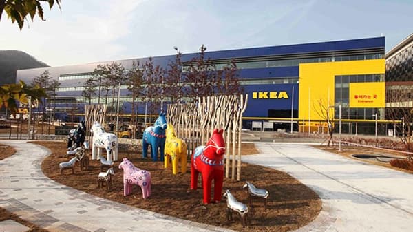 A blue IKEA store building with a giant IKEA logo in yellow.