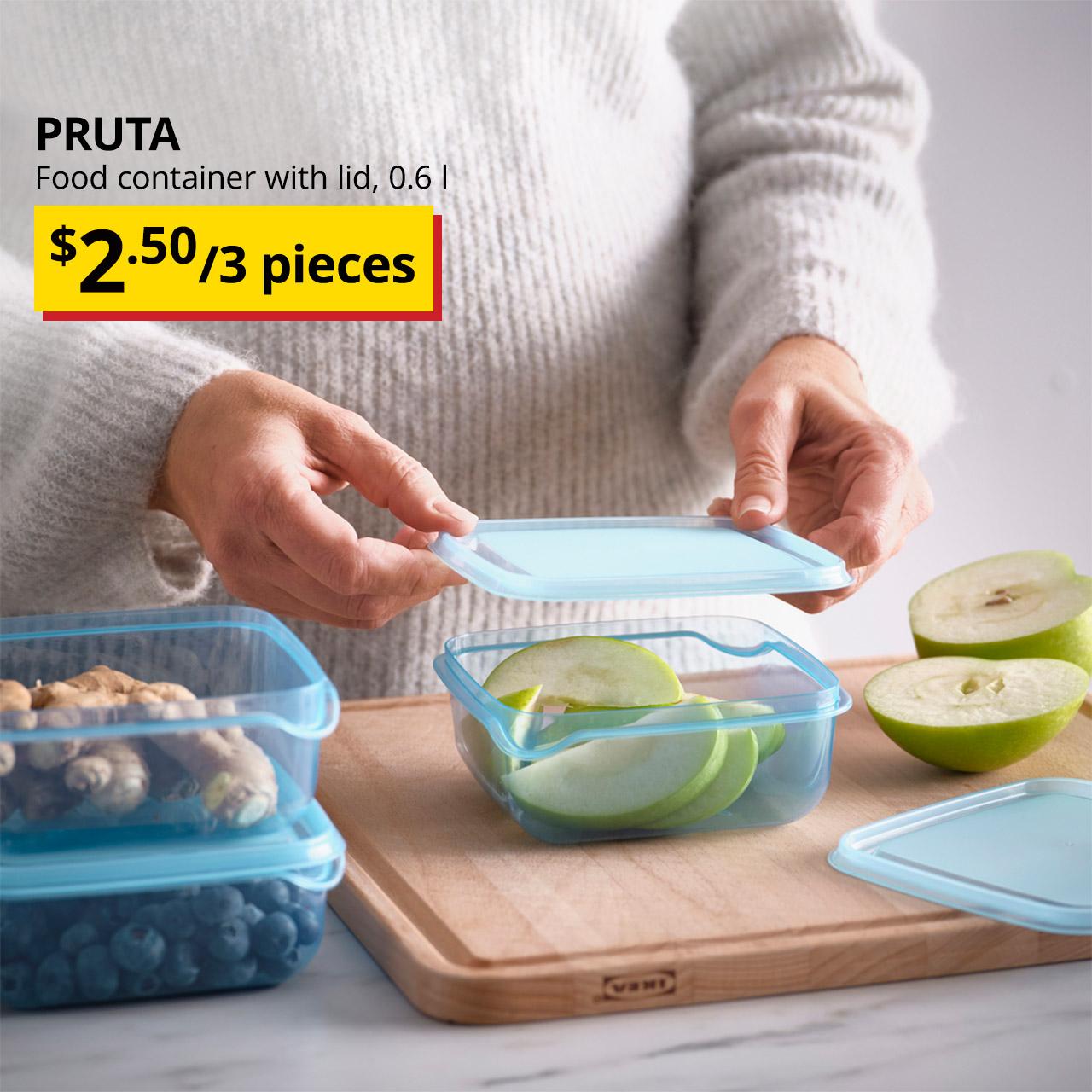 A blue PRUTA food container with sliced green apple being placed in it for storage. Black text over image on the left that reads "PRUTA, Food container with lid, 0.6 l", with breath-taking price tag of $2.50/3 pieces.