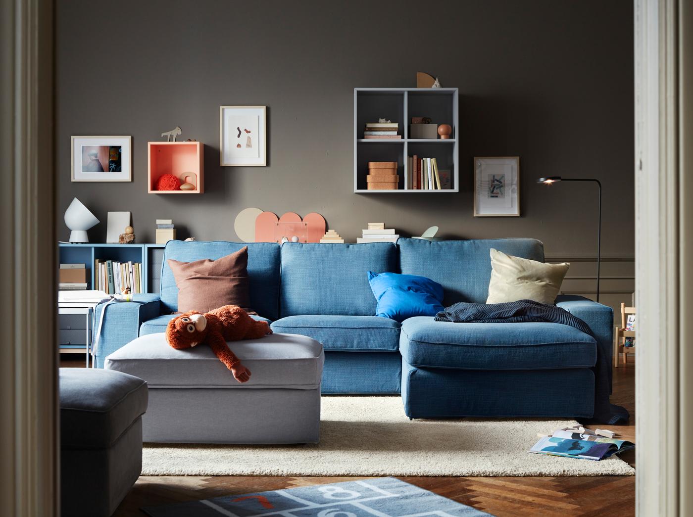 A blue sofa in a room with wall mounted open shelving.