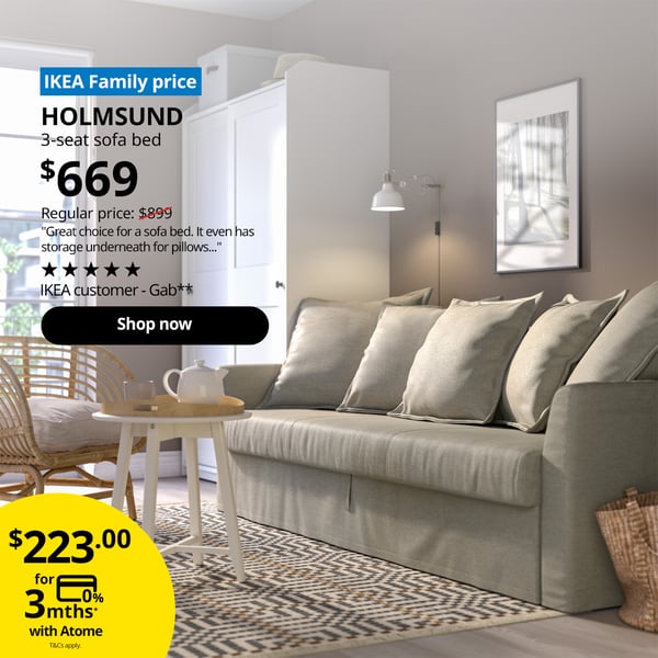 A Borgunda beige HOLMSUND sofa bed. A blue tag with white text that reads 