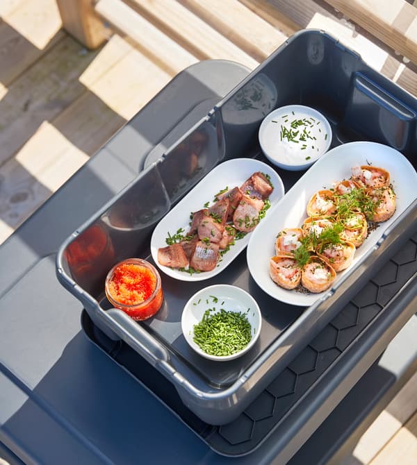 A box containing trays of prepped food.