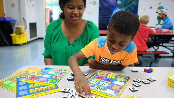 A boy and mother playing a game.