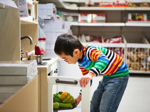 A boy is checking out the product in the kid's section.
