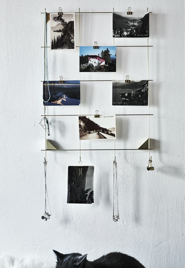 A brass picture frame with photos.