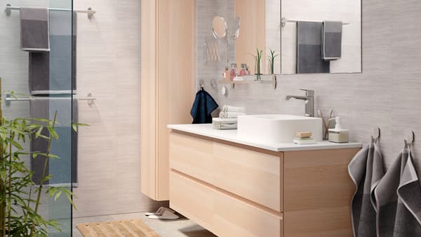 A bright and elegant bathroom with a GODMORGON wash-stand and GODMORGON high cabinet in white stained oak effect.