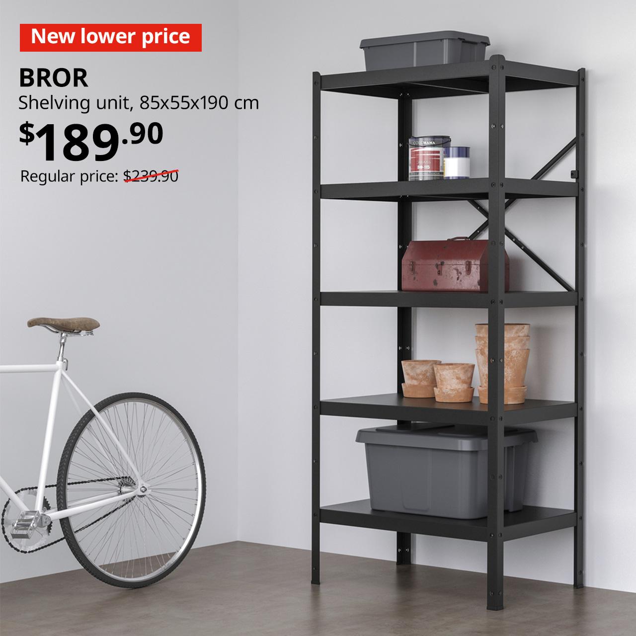 A BROR shelving unit in black is being used to place paint supplies and tool box. Red tag with white text that reads "New lower price". White text overlay image that reads "BROR, Shelving unit, 85x55x190 cm. Price at $189.90, previous price was $239.90"