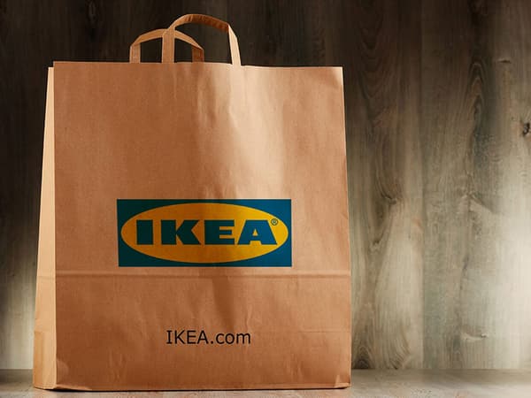 A brown paper bag bearing an IKEA logo and the text 'IKEA.com'.