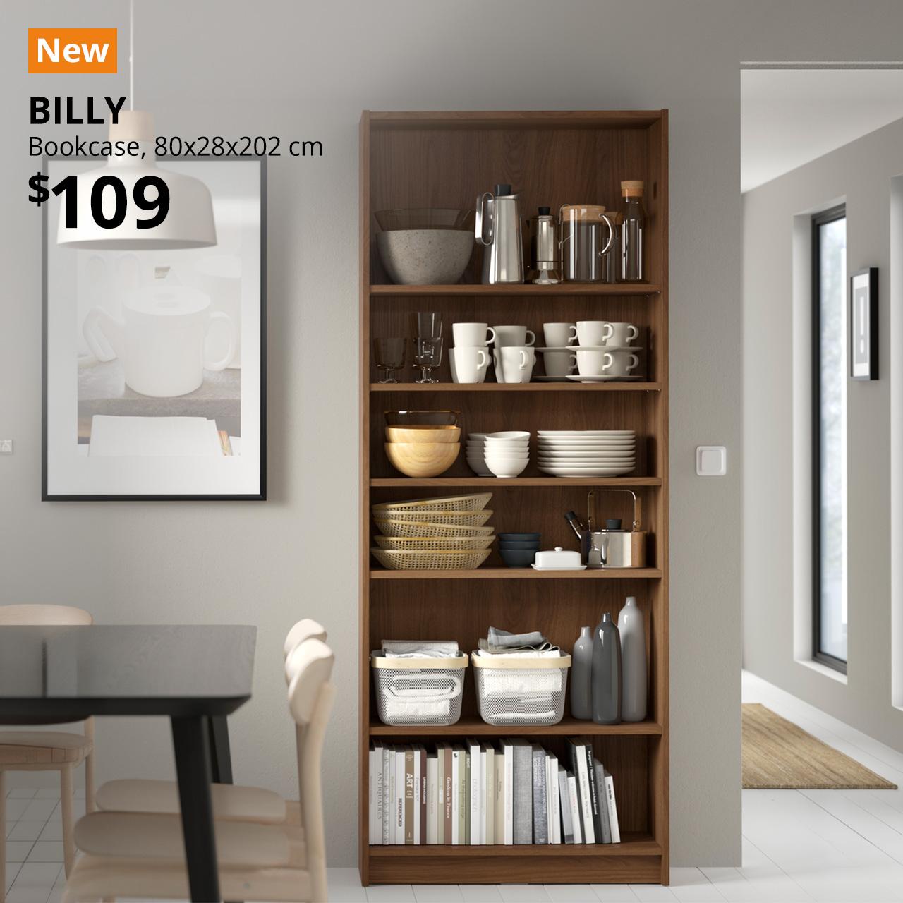 A brown walnut effect BILLY bookcase in a living/dining setting. An orange "NEW" label is on the top left of the image with black text that reads: BILLY, Bookcase, 80x28x202cm, Price is $109".