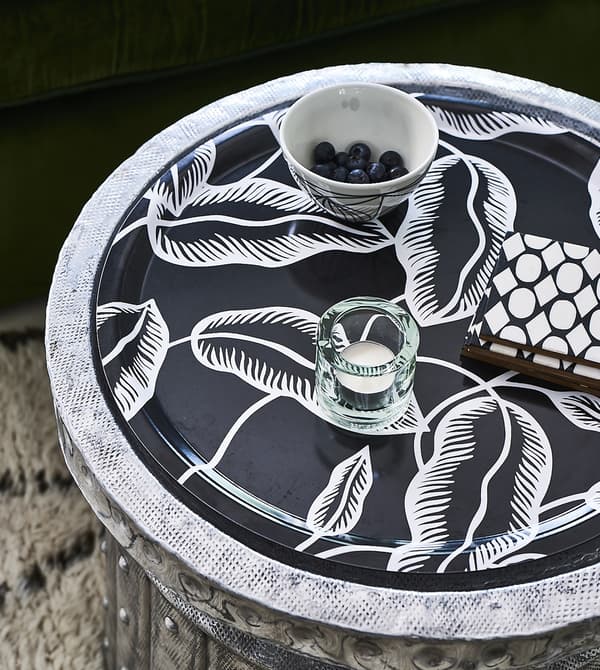 A candle and bowl on a tray.