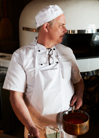 A chef lifting a pot