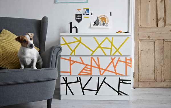 A chest of drawers decorated with washi tape.