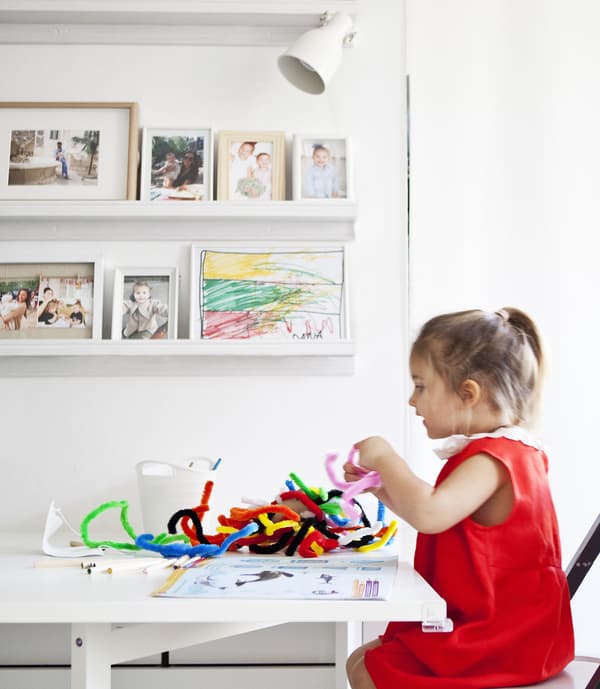 A child doing arts and crafts at the dining table.