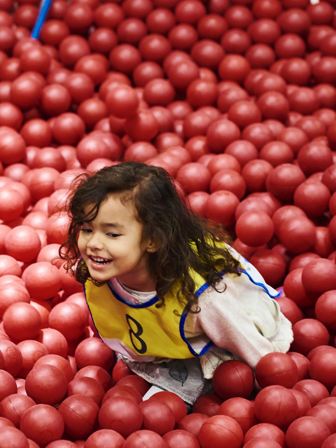 A child playing in an IKEA SMÅLAND area.