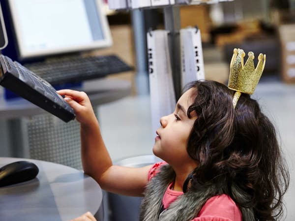 A child reaches for the keyboard