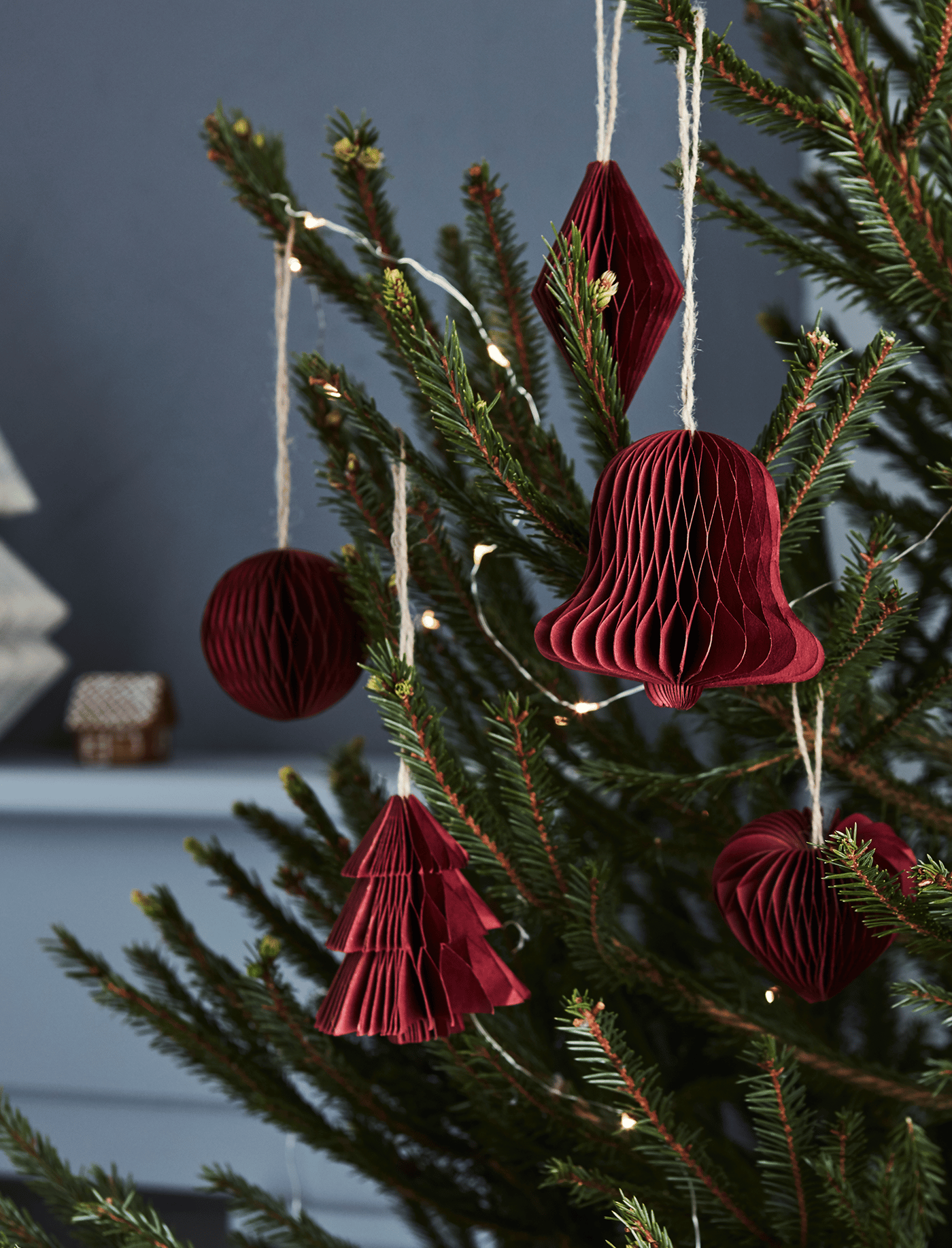 A Christmas tree with red tree ornaments.