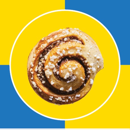 a cinnamon roll on a blue and yellow checkered background
