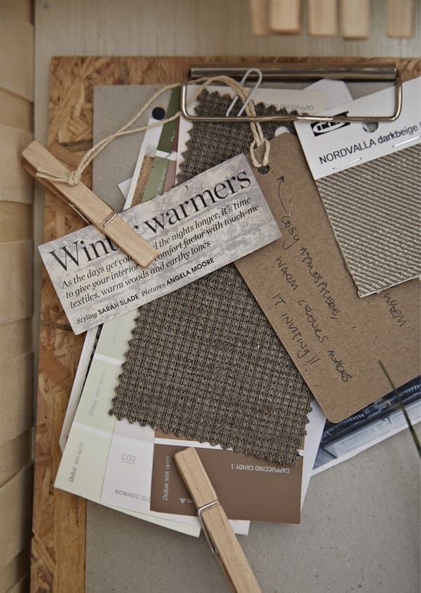 A clipboard with clippings and textile samples.