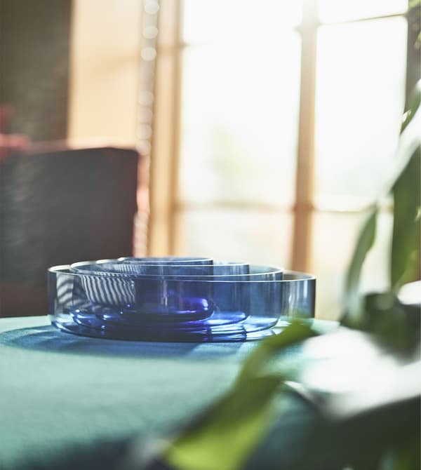 A close-up image of a set of blue glass serving bowls.