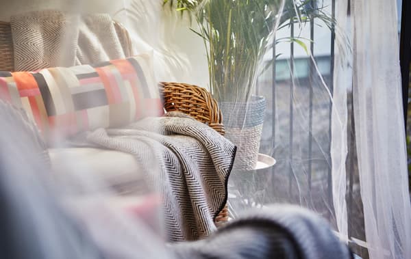 A close-up image of a sitting area beaneath a sheer canopy.
