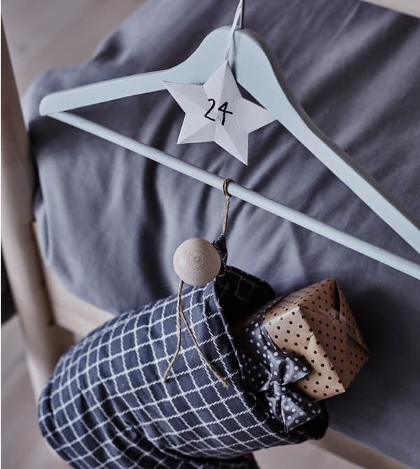 A close-up image of a stocking hanging at the foot of the bed.