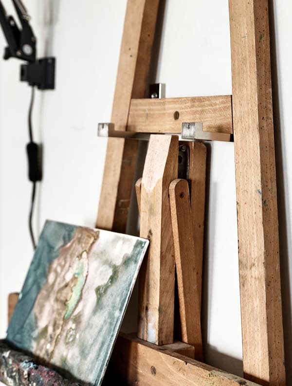 A close-up image of an easel hanging on a wall.