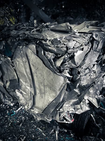A close-up image of crumpled metallic sheets.