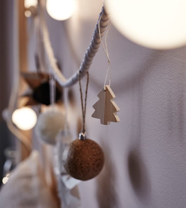 A close-up image of ornaments and lights strung from a headboard.