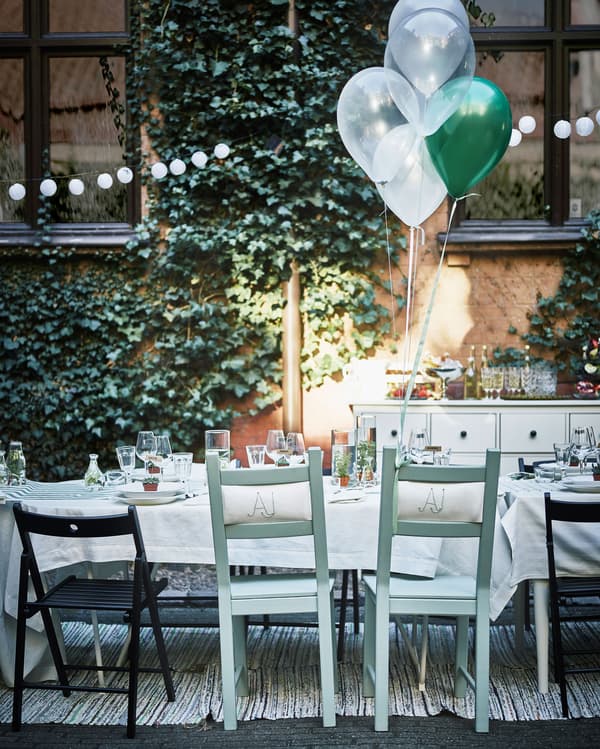 A close-up image of the bridal pair’s custom seats, with balloons tied to the back.