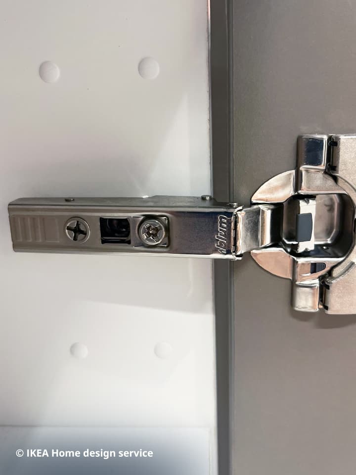 A close up look of a blum soft-closing hinges located in pull-out drawer in the base cabinet of IKEA METOD kitchen system.