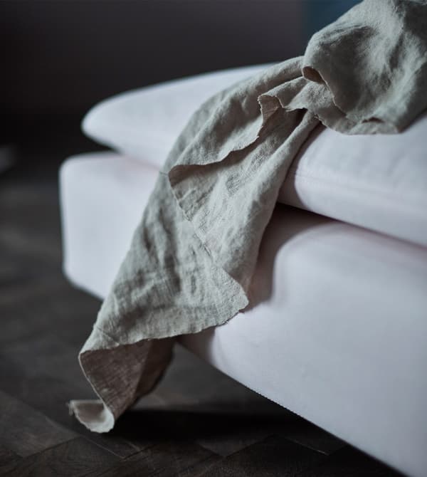 A close up of a curtain on a chaise.
