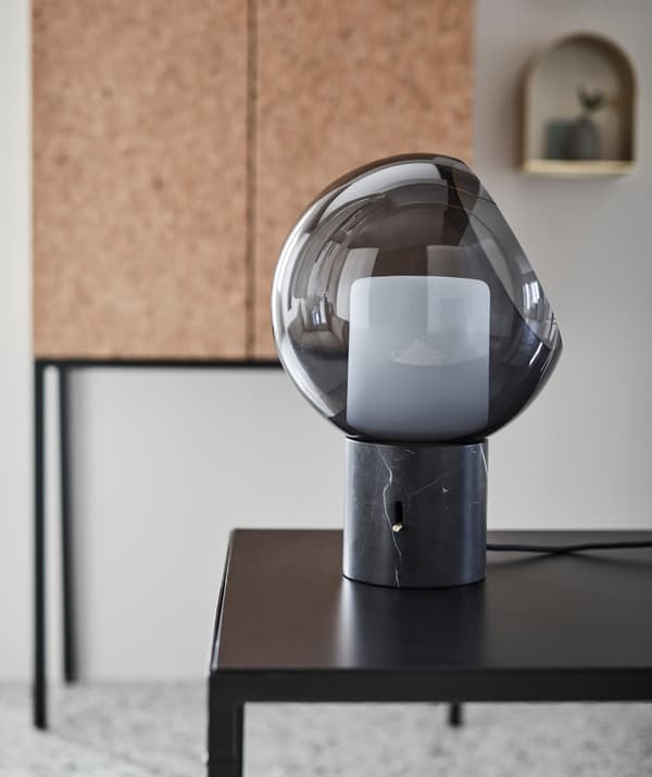 A close-up of a dark grey EVEDAL table lamp with globe shape.