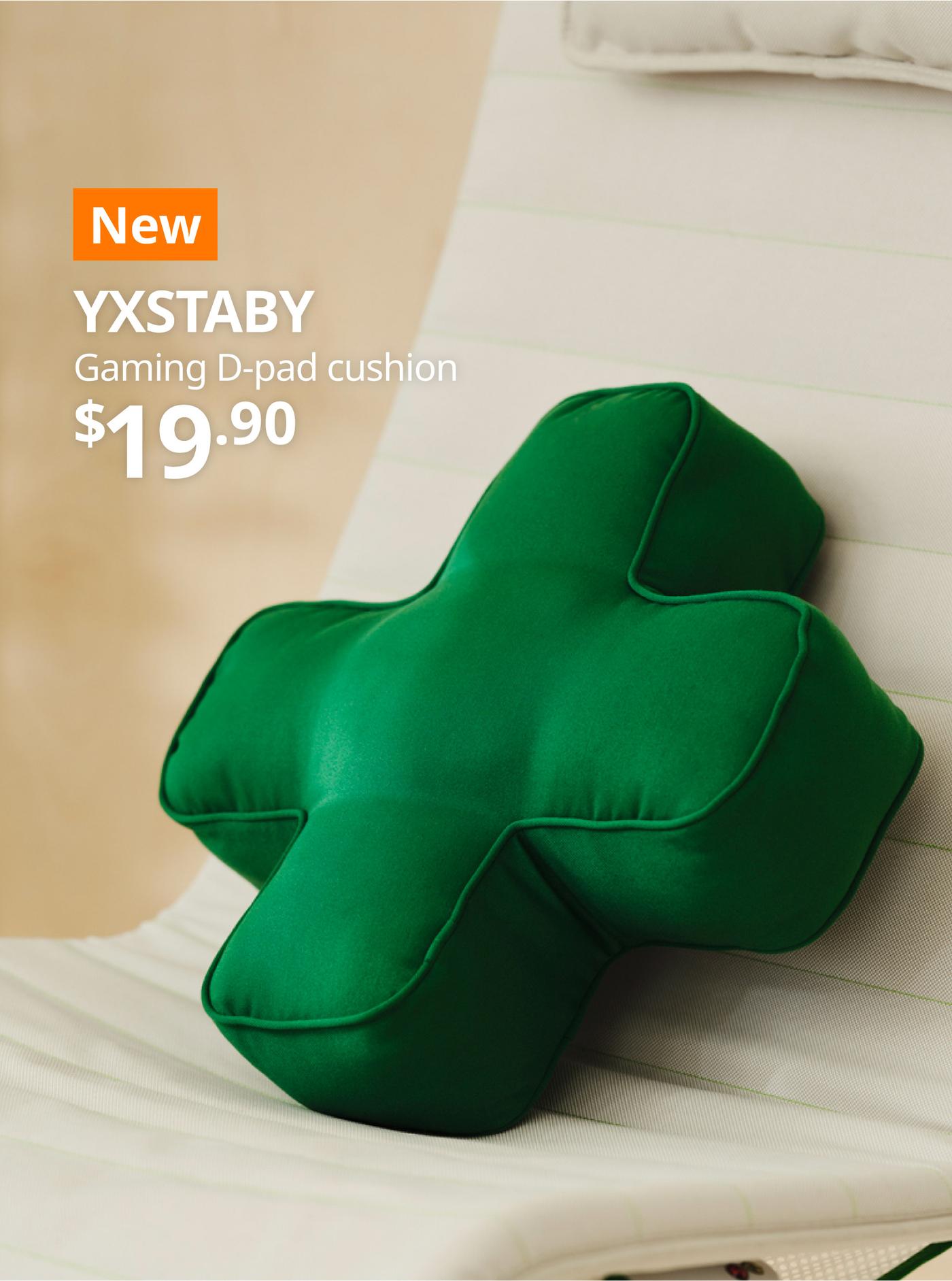 A close-up of a green YXSTABY gmaing D-pad cushion placed on a YXSTABY vissle beige gaming lounge chair. On the top left, a orange tag with white text that reads 'New', followed by white text overlay image that reads 'YXSTABY, Gaming D-pad cushion, $19.90'.