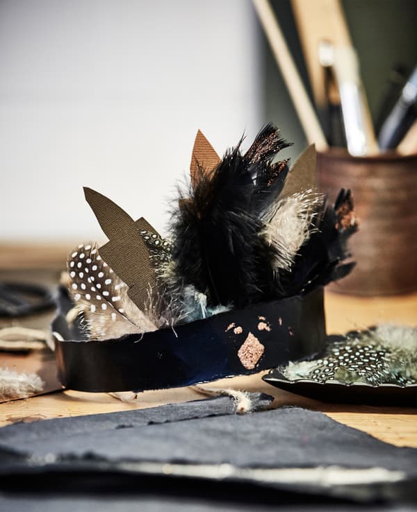 A close up of a harvest-themed head band shaped that looks like a turkey with feathers.