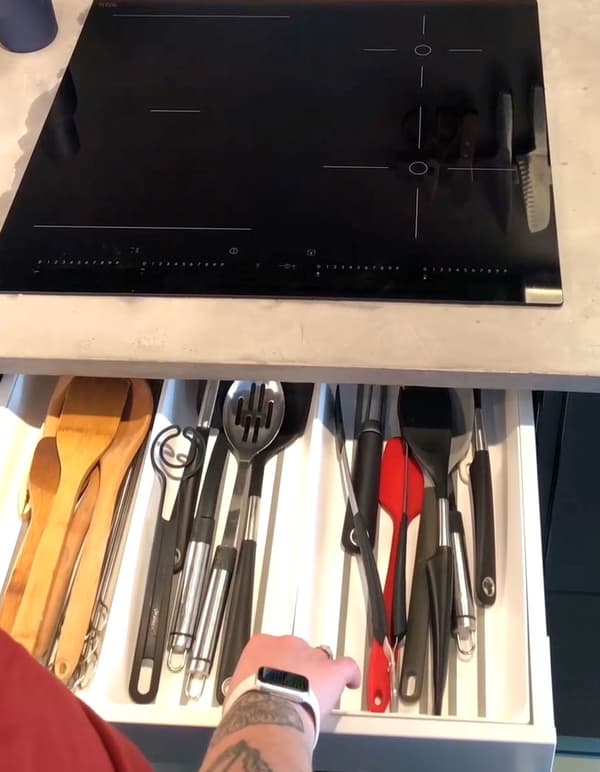 A close up of a kitchen drawer with an IKEA VARIERA utensil tray.