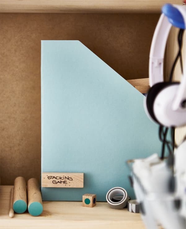 A close-up of a magazine file with the pieces of a stacking game inside.