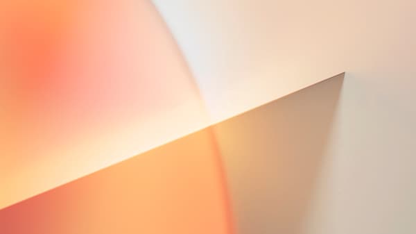 A close-up of a sheet of glass interacting with light, creating a hazy effect.